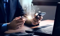 A man holding a smartphone in one hand and a payment card in the other, ready to make a digital transaction.