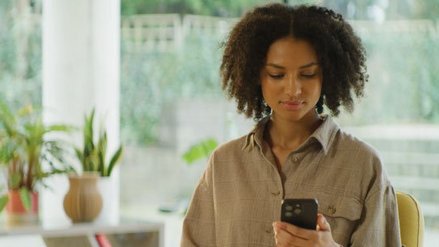 Woman looks at her cell phone