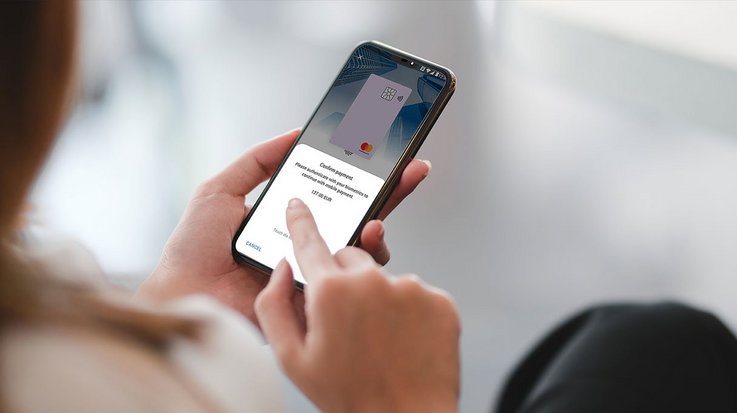 A woman uses a mobile wallet on her smartphone