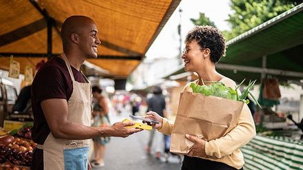 Customer making a contactless payment at a farmers' market