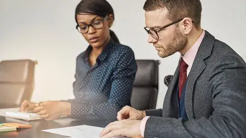 Two people reviewing documents