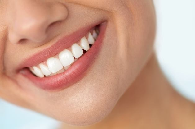 Close up of person with straight white teeth smiling