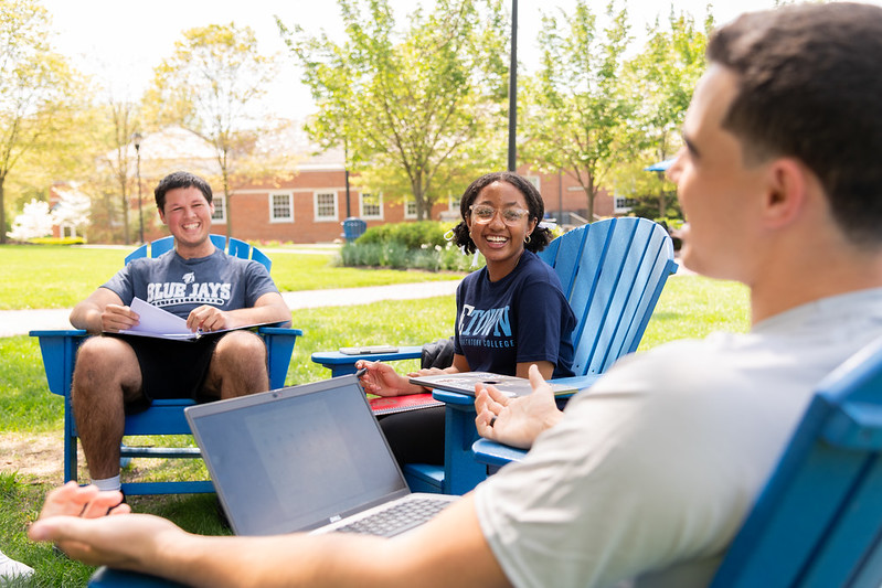 students sitting in the center of campus