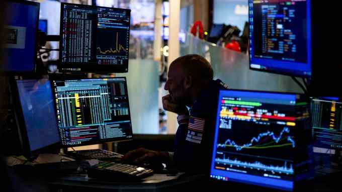 A trader works on the floor of the New York Stock Exchange in New York