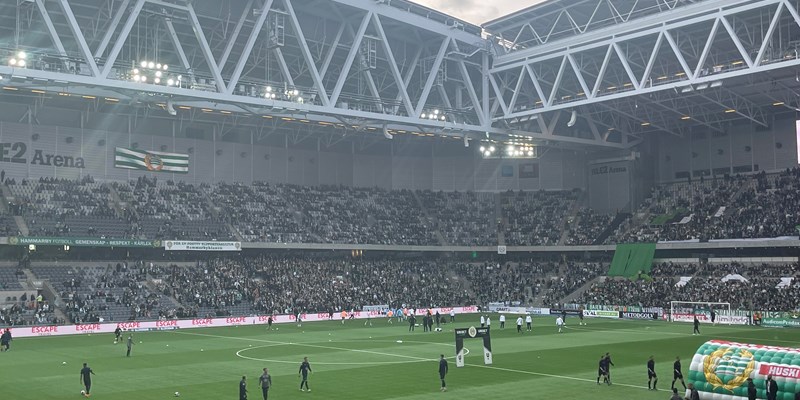 Football players kicking a ball on a football pitch