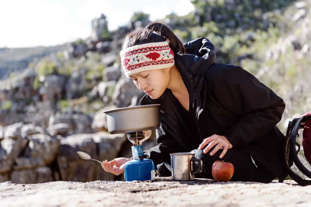 Woman making food outside