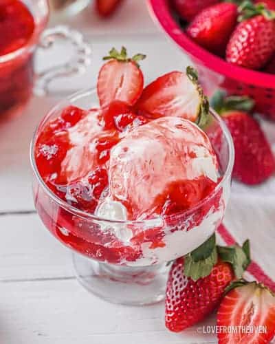 a bowl of ice cream with strawberry sauce on it