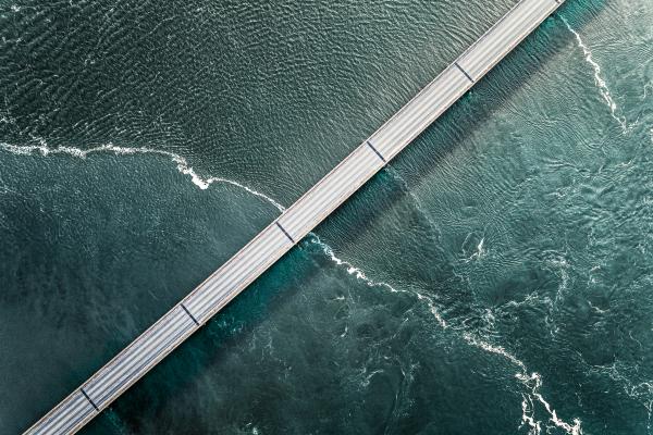 Diagonal road over turqoise water