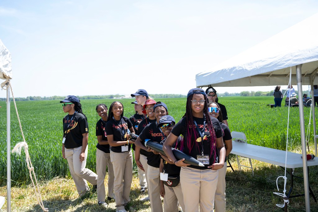 The student team from Victory Christian Center School in Charlotte, North Carolina, pose with their rocket prior to launch.