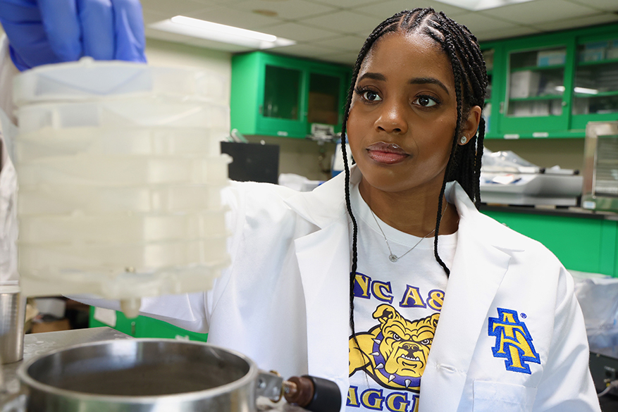 white man with beard on the Farm wearing the A&T Farm logo on his shirt
