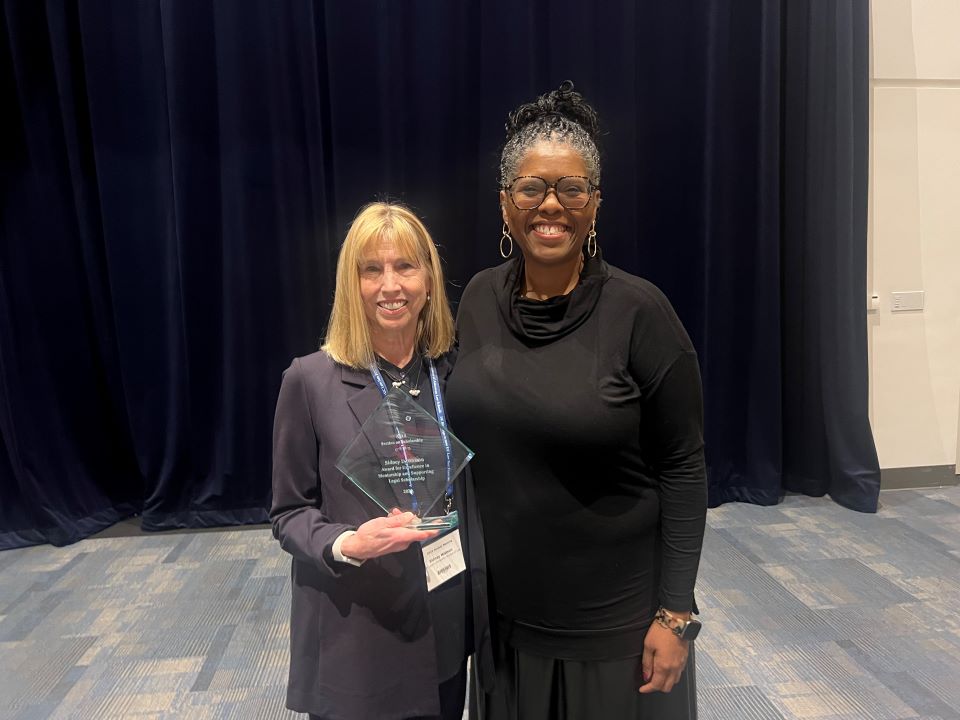 Professor Sidney Watson is joined by Dean Twinette Johnson after receiving her award at the annual AALS meeting