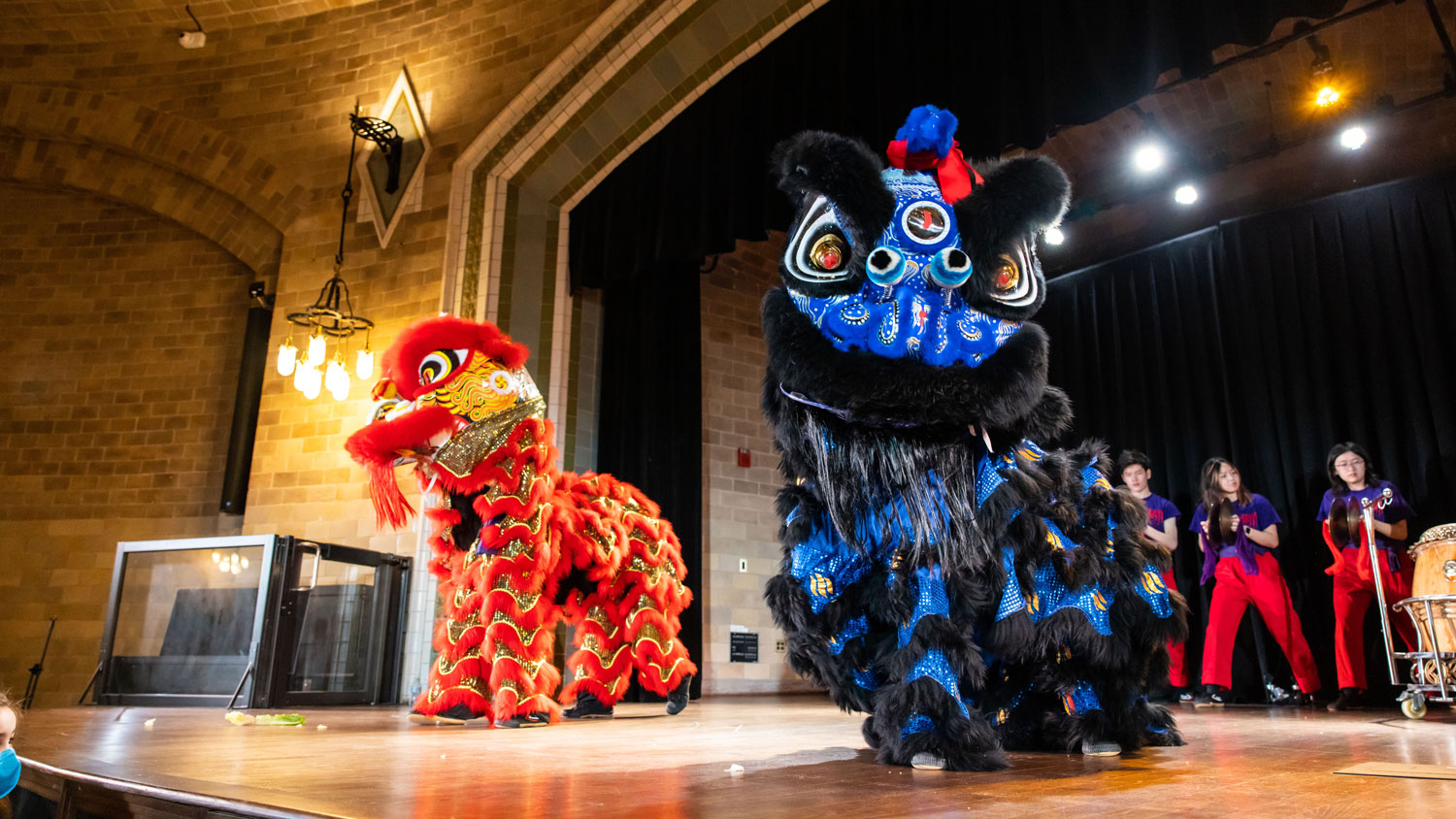 A lion dance on the Harrison Auditorium stage.