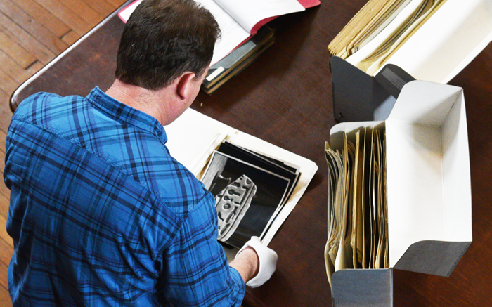 An archivist working with materials.