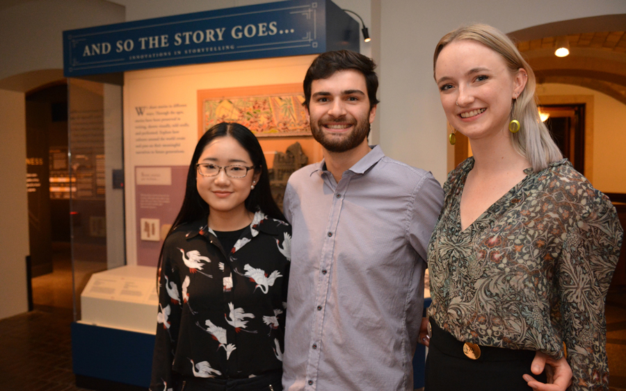 Students posing with artifacts.