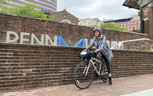 A person on a bike in front of the museum.