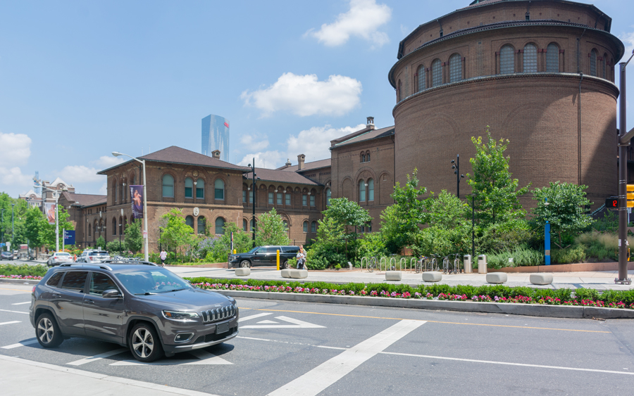 A car on the road in front of the Penn Museum.