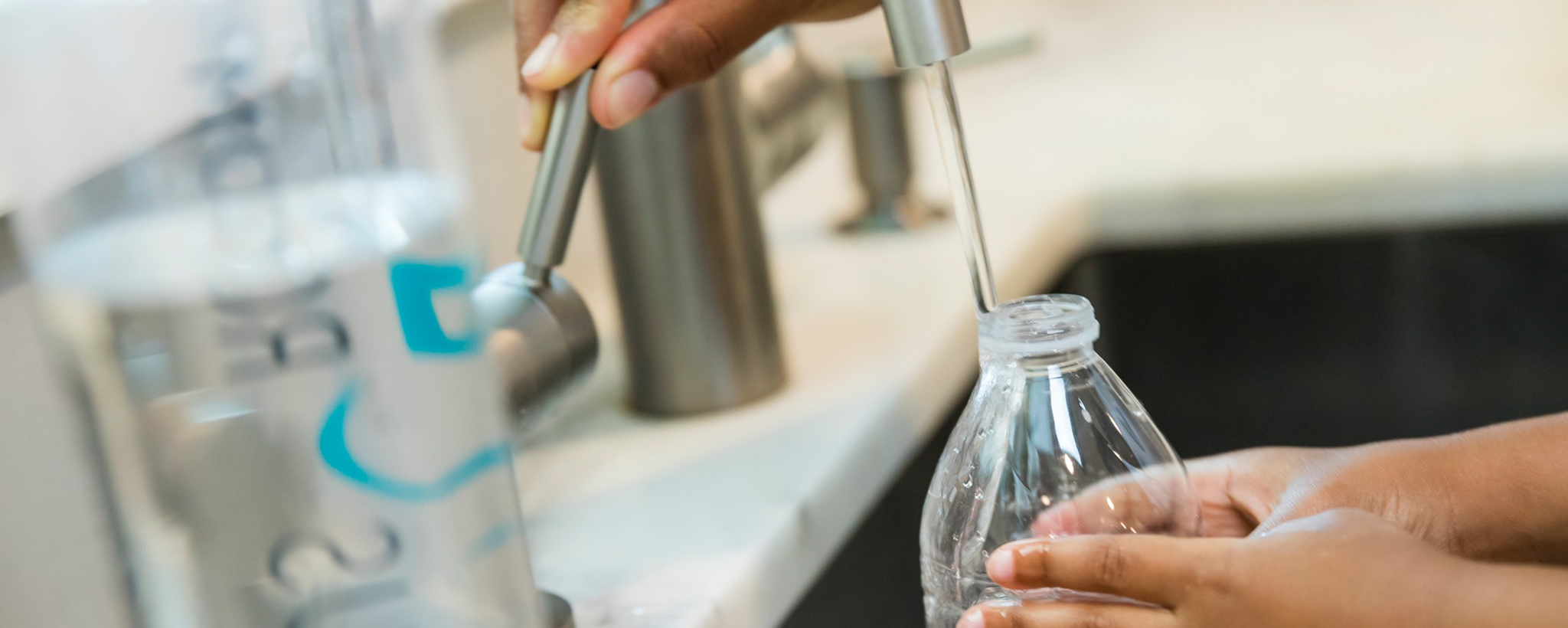 Filling a plastic water bottle with tap water