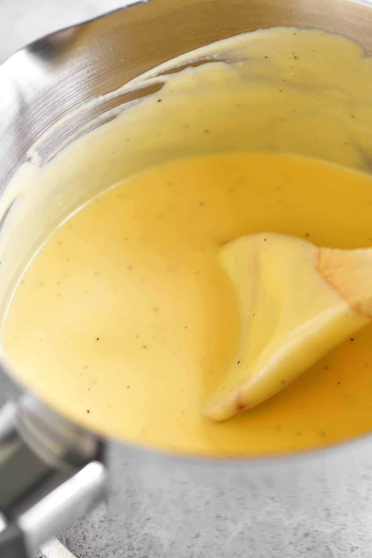 a close-up photo of the cheese sauce in the saucepan