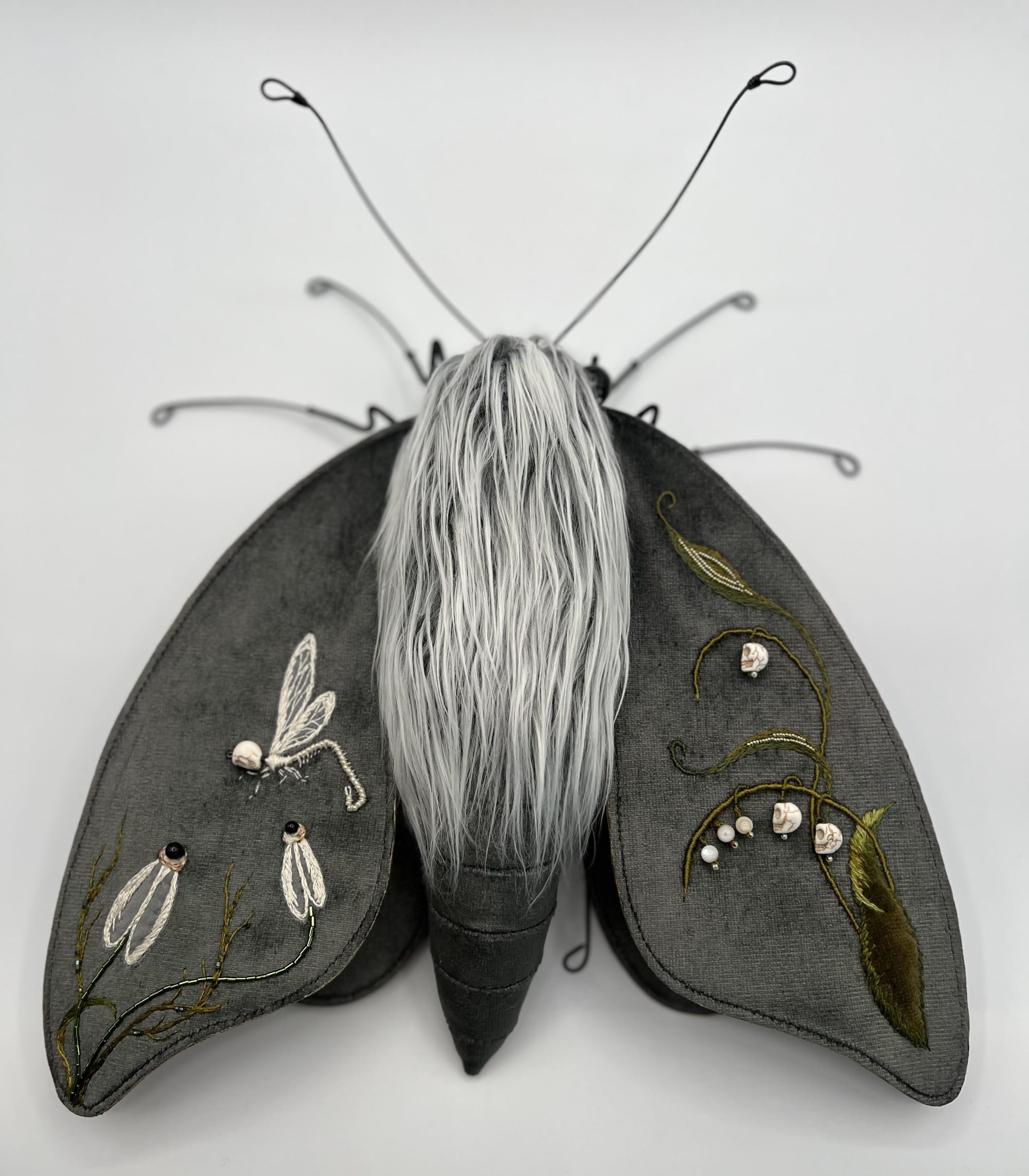 a moth sculpture made from textile and wire