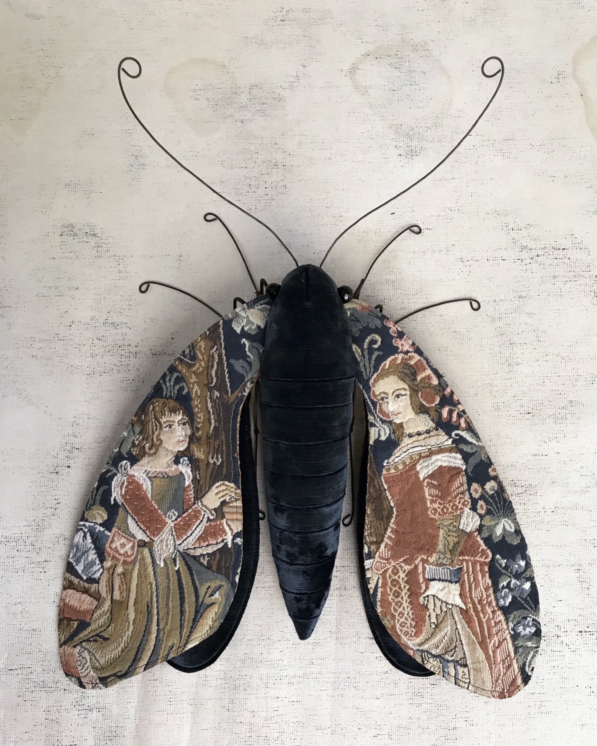 a moth sculpture made from textile and wire