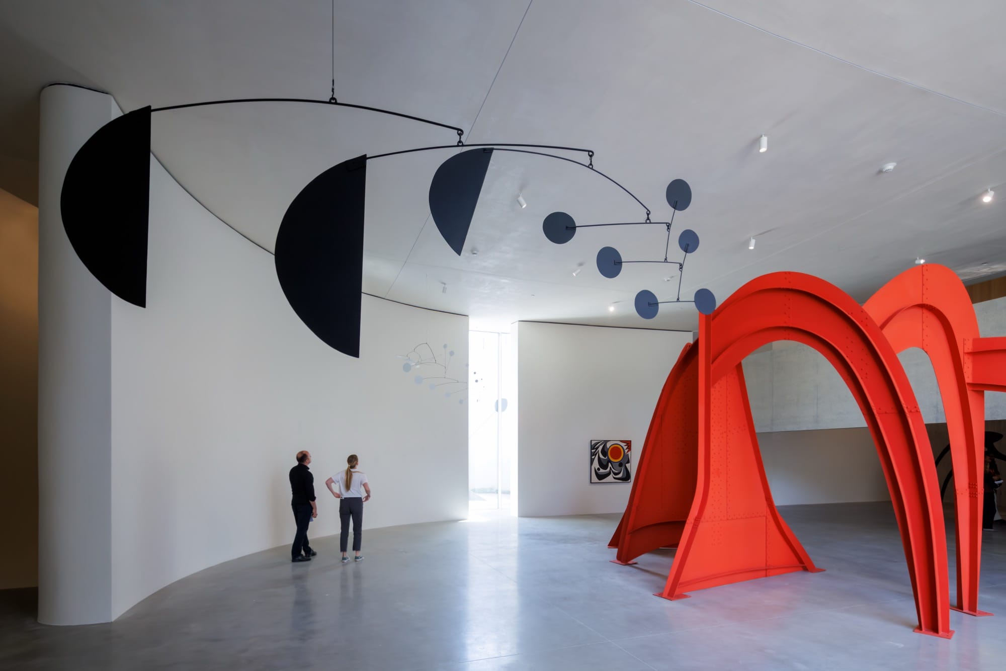 the open atrium at Calder Gardens with two large-scale sculptures in red and black and a large hanging mobile