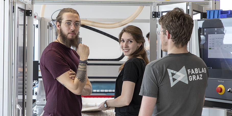 3 people in an industrial laboratory