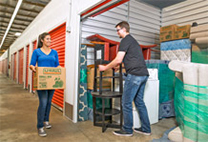 A couple loading a storage container.