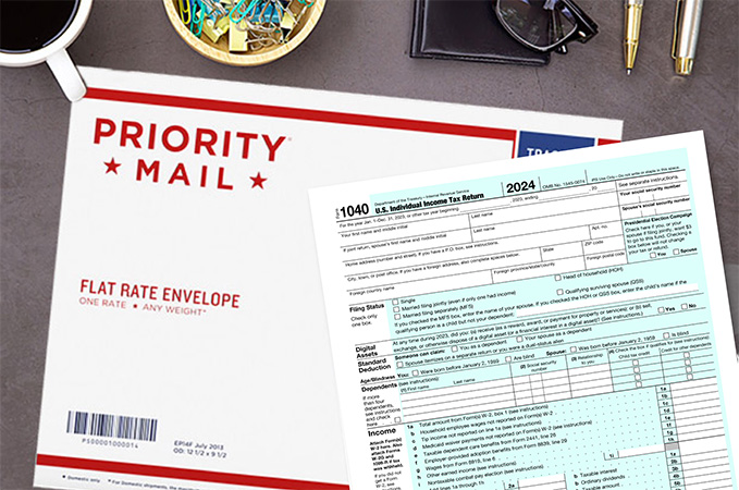 An IRS form 1040 and a Priority Mail Flat Rate envelope on a desk.