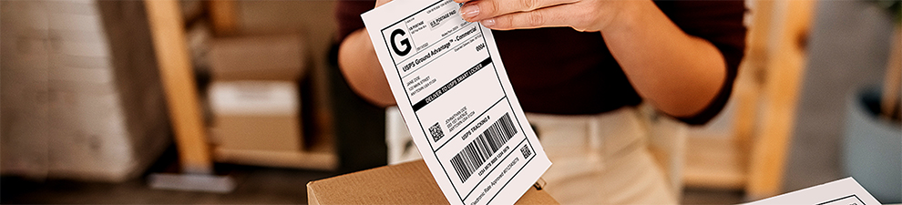 A label printed from the Click-N-Ship service being applied to a package for shipping.