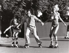 Hugh Hefner Hits the Roller Rink With Playmates, 1974 by Julian Wasser 