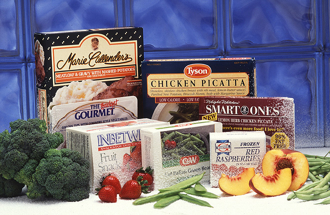 Boxes of frozen/processed foods, along with fresh fruits and vegetables