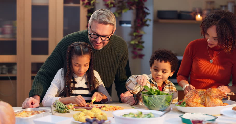 Cooking, family and kids help parents with dinner for thanksgiving in home. Children, mom and dad prepare turkey meal, food and chopping healthy organic vegetables with interracial people in kitchen