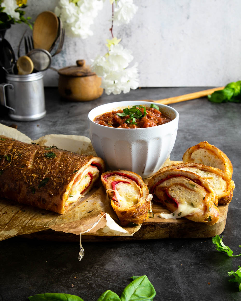 A sliced up, ready to eat Stromboli on a black marble counter.