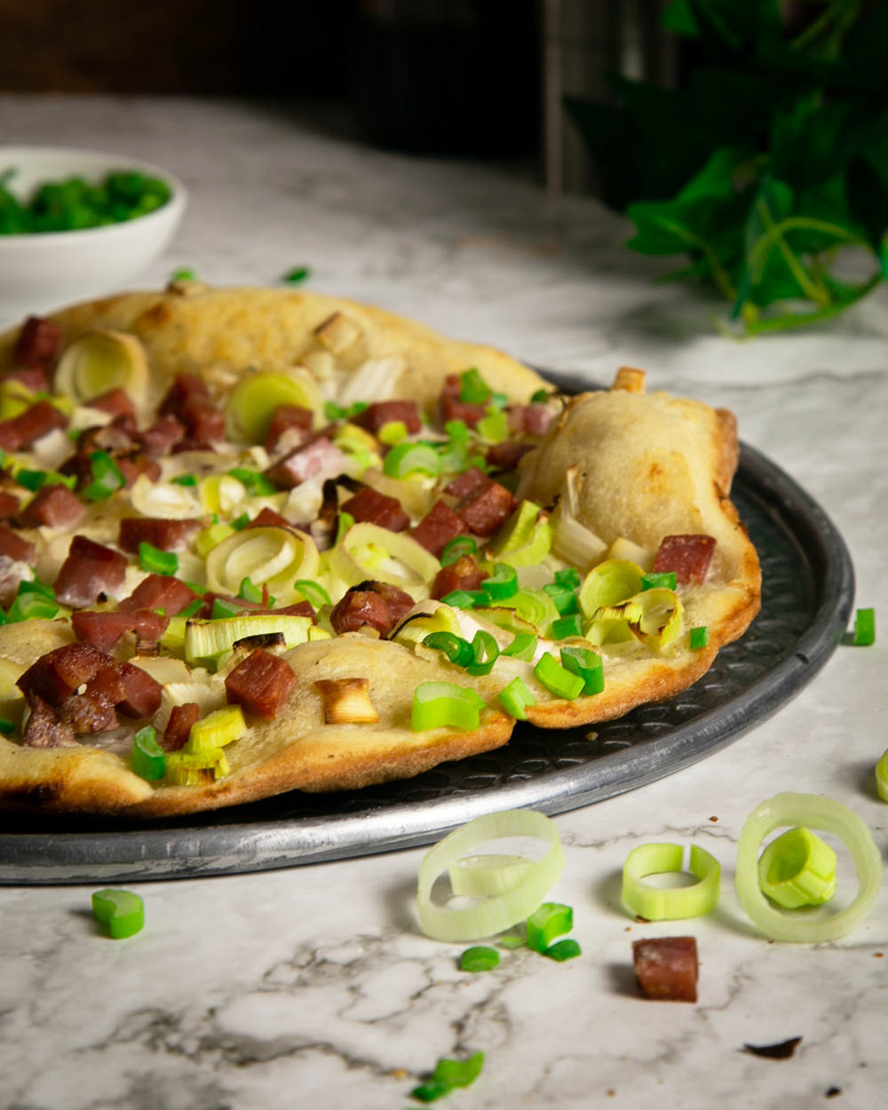 45 degree angle of a flammkuchen on a pizza pan.