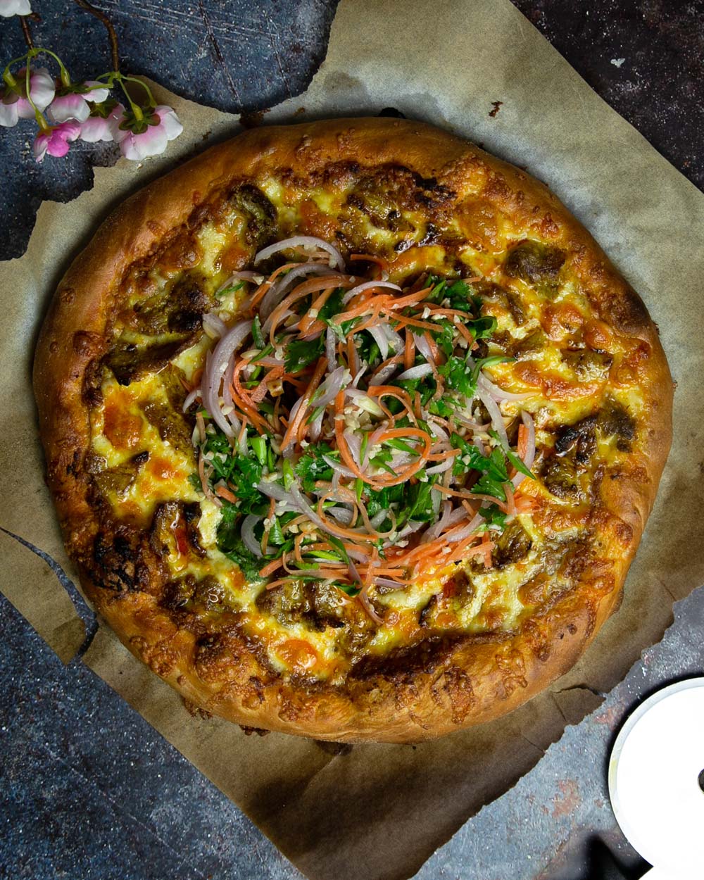 Top view of the Thai satay pizza on a dark marble background.