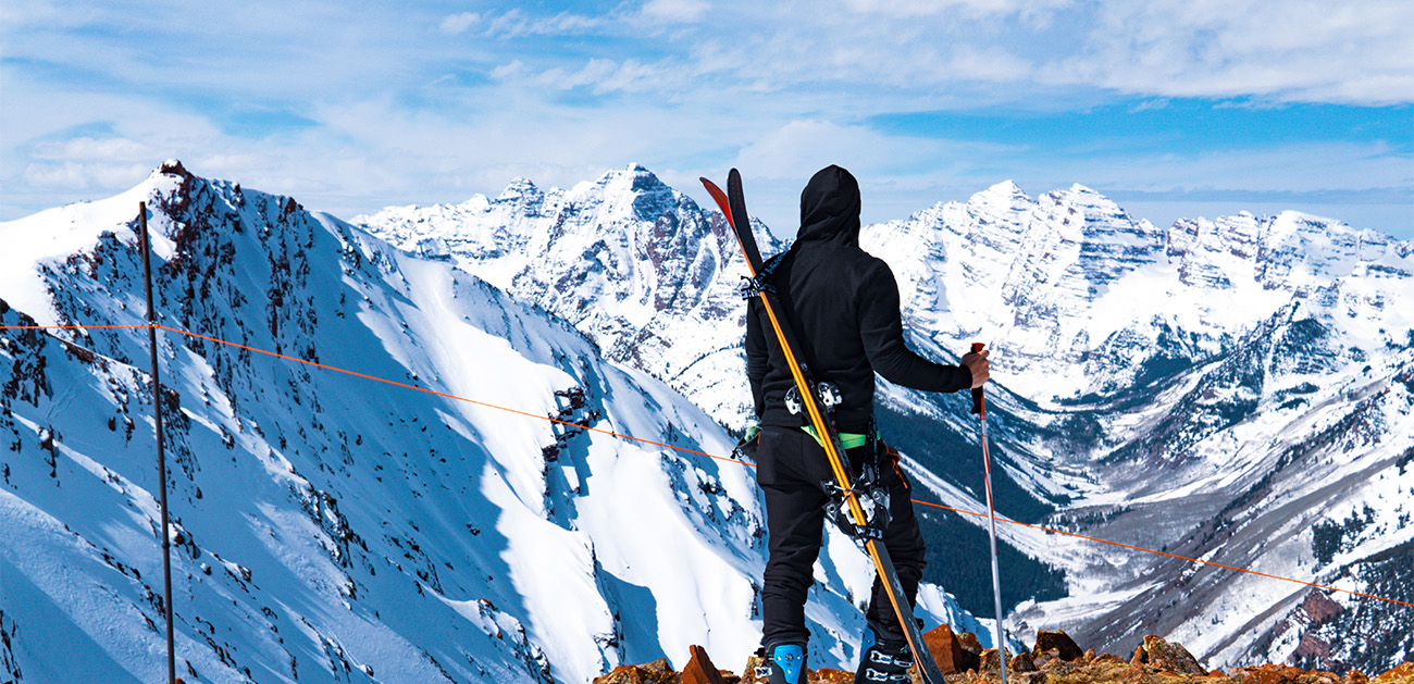 Man resting after hiking up Highlands Bowl in Aspen, Colorado during winter