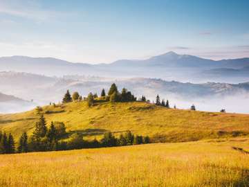 Misty alpine highlands in sunny day. jigsaw puzzle online