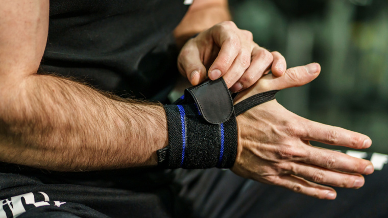 Man Putting On Wrist Wraps