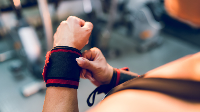 Person putting on wrist wraps