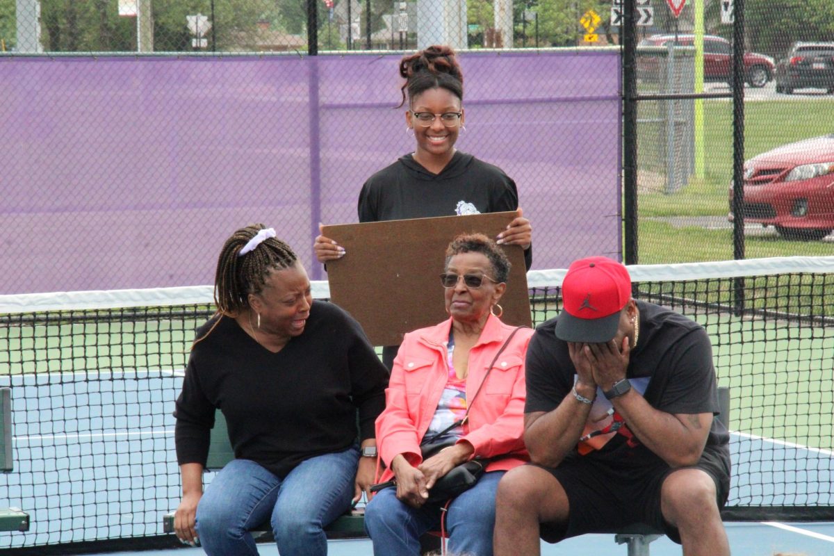 Lewis and her family contemplate their next answers and guesses for the game at practice.