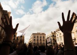 Hands raised during a protest in a city square