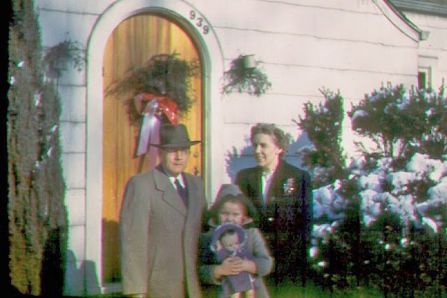 Mom/Dad/Betsy standing in front of our home at Christmas, 1946