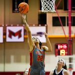 Mara Rieder shoots a layup as a defender looks on