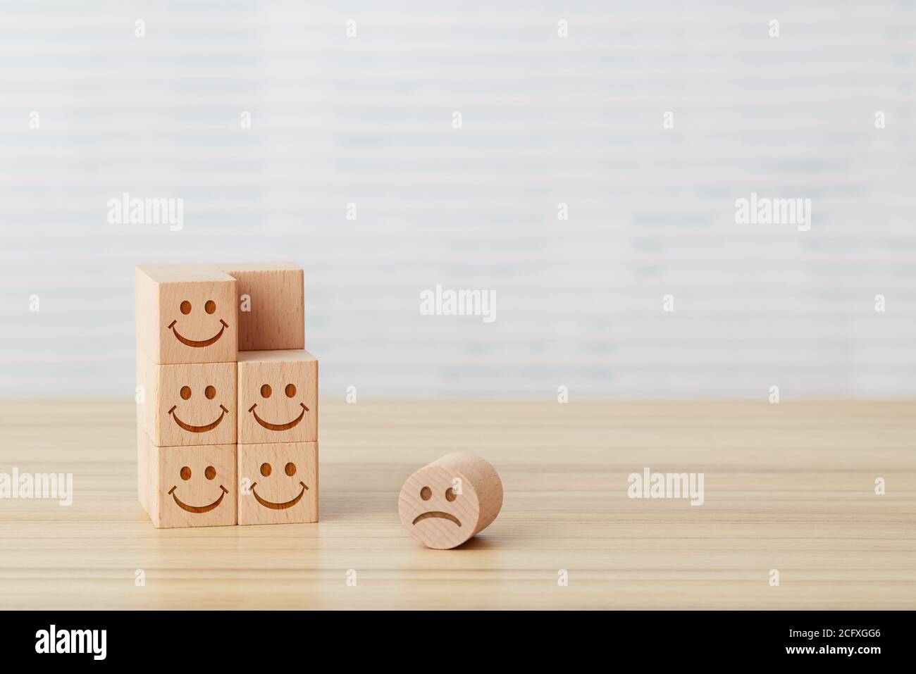 Sad face on wooden cube Stock Photo