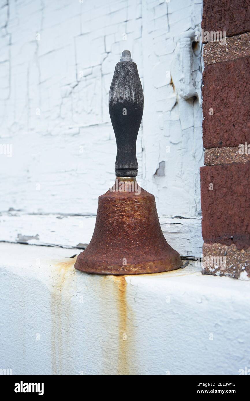 Old, rusty school bell. Stock Photo