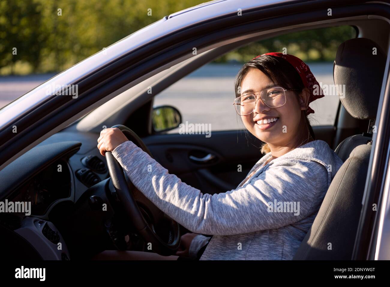 Smiling woman sitting in car Stock Photo