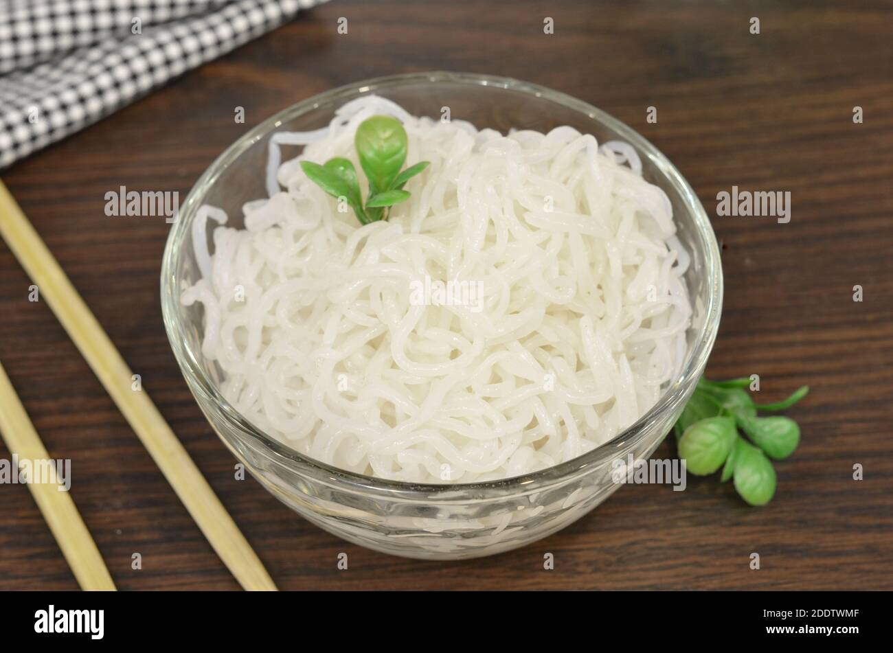 Konjac or Shirataki noodles with Chinese chopsticks. Japanese traditional dish. Healthy food for weight loss, keto diet concept Stock Photo