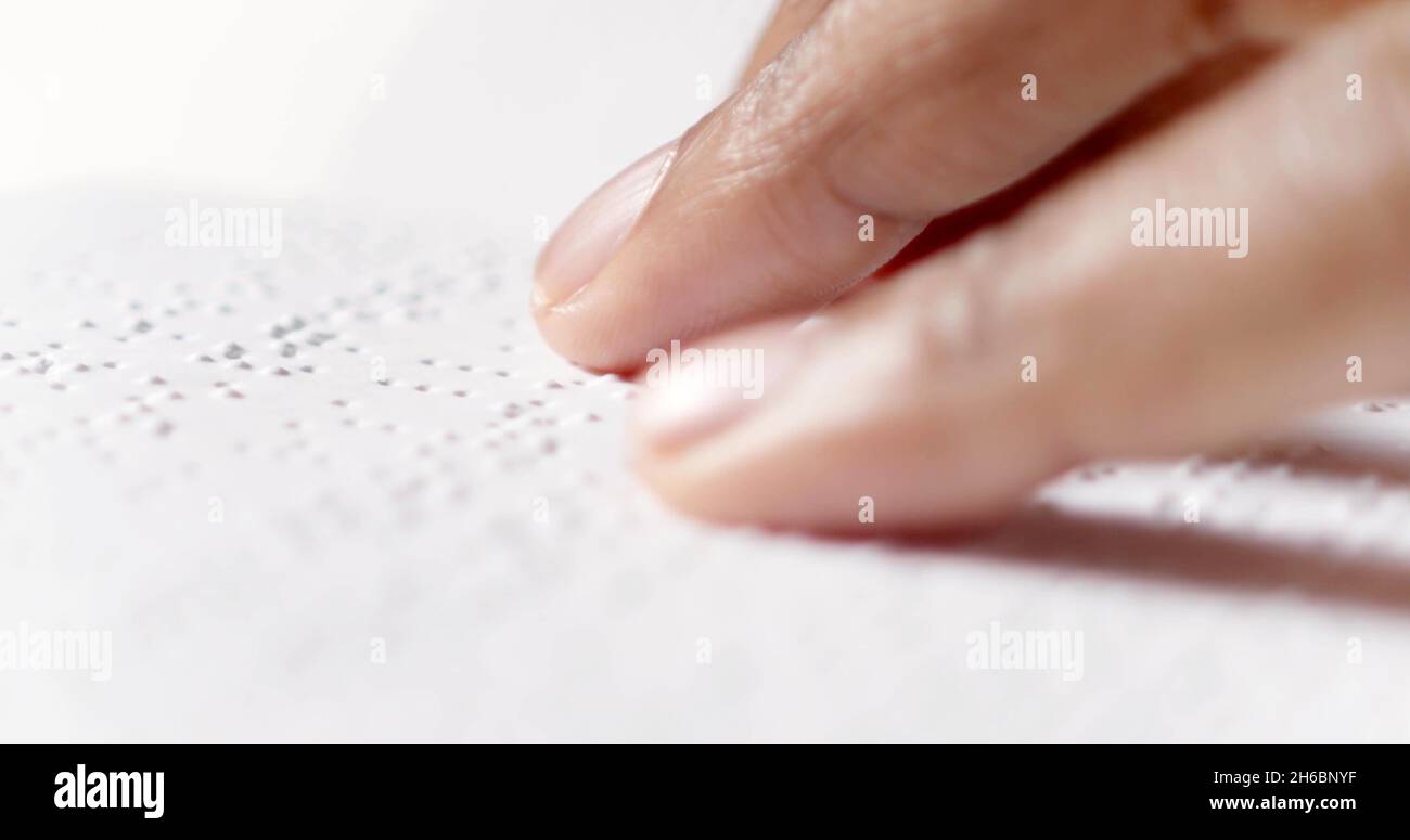 A finger is reading braille Stock Photo