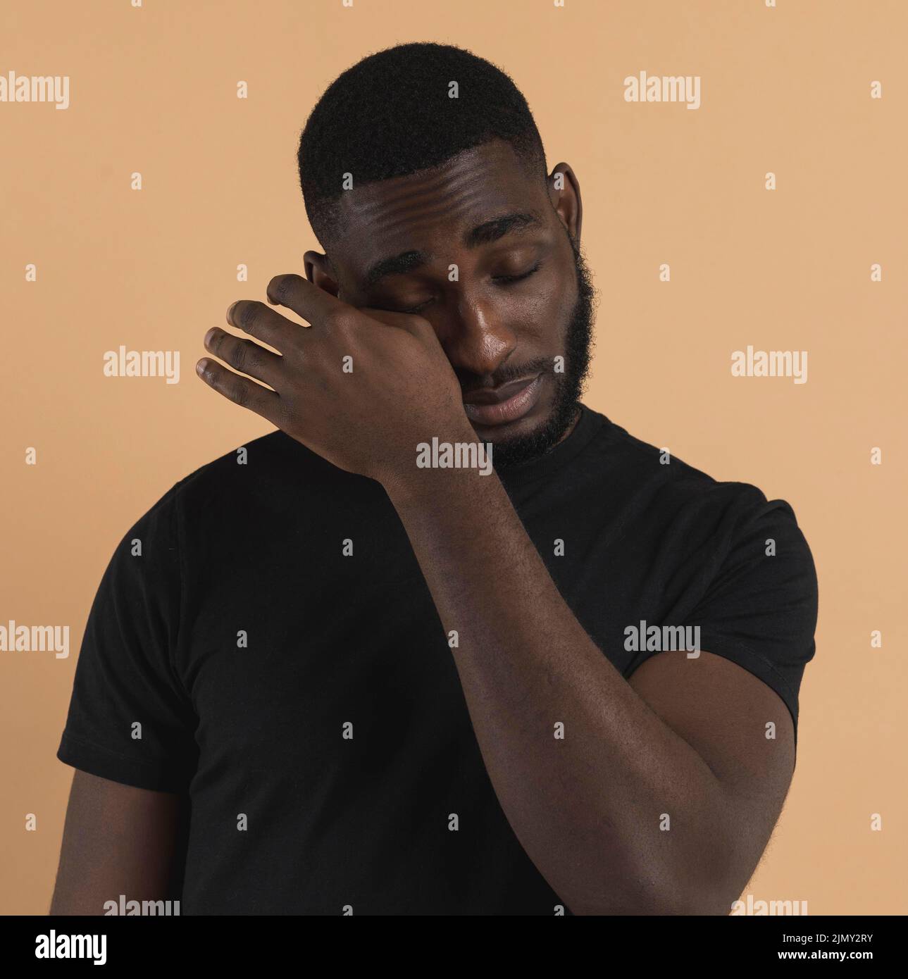 Person wiping away his tears Stock Photo