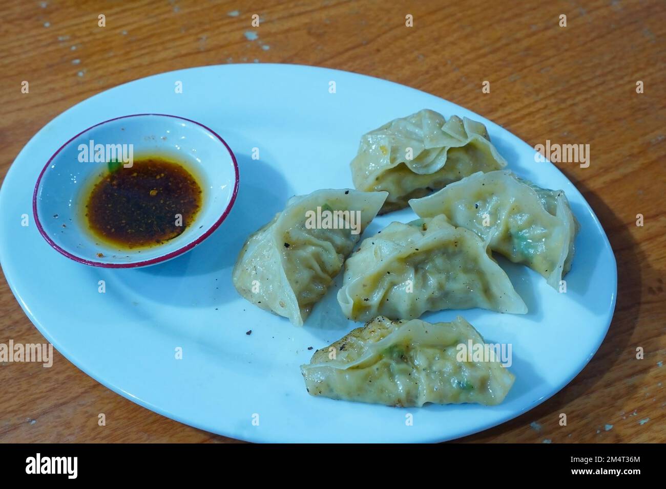 Japanese goyza dumpling served on plate with chili oil Stock Photo